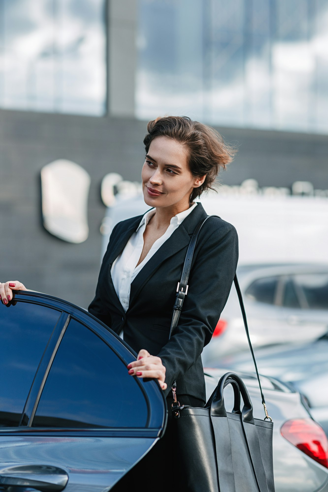 Caucasian businesswoman standing at the taxi. Young female entering a car.